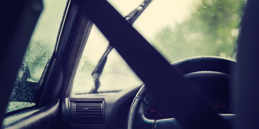 Driver wearing seat belt in a car. 