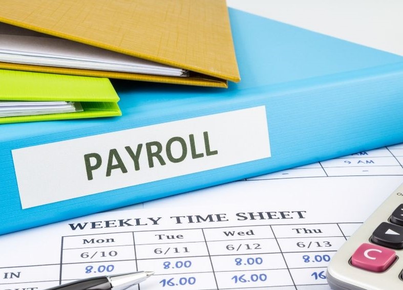 Image of a payroll binder and sheet