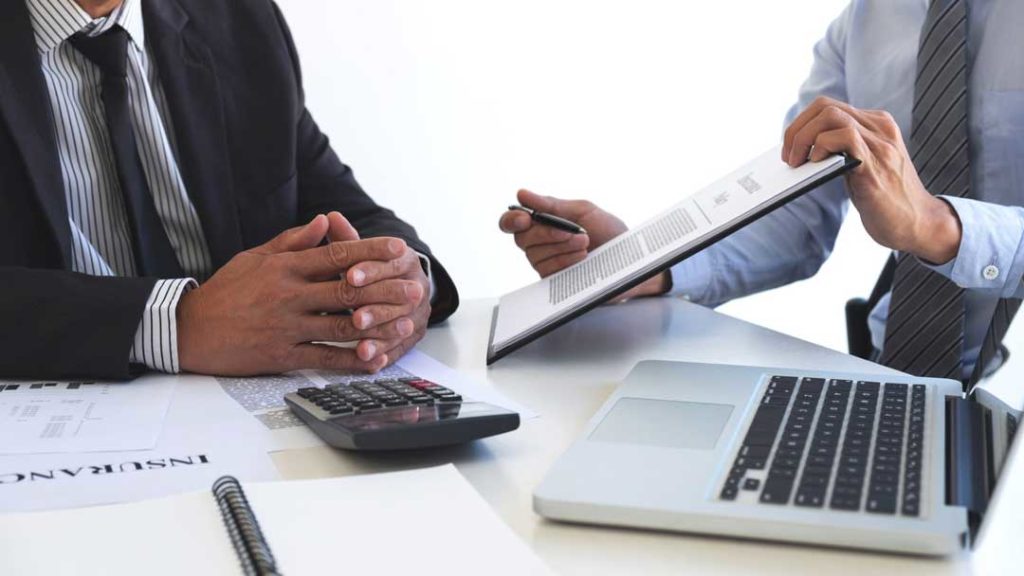 insurance salesman and professional engineer discussing the best liability insurance