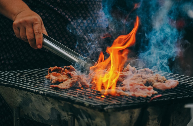 someone cooking on the grill