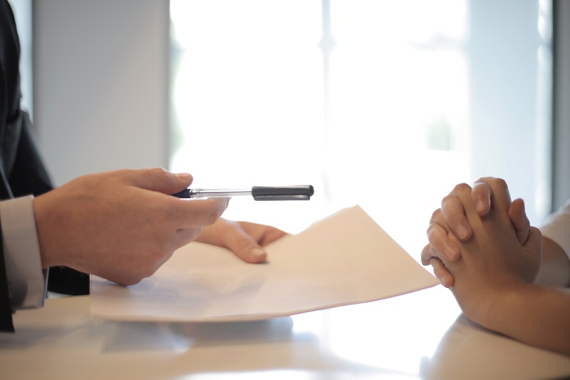 someone signing paperwork